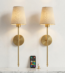 Pair of gold wall sconces mounted above marble console