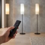 Hand using remote control to adjust floor lamp brightness