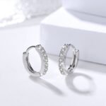 Sterling silver hoop earrings styled on white display blocks