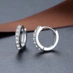 925 sterling silver hoop earrings with zircon stones on leather background