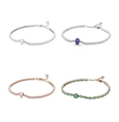 Collection of four sparkling tennis bracelets in silver, blue, rose gold pink and green